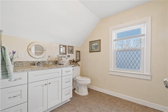 bathroom with vanity, lofted ceiling, tile patterned floors, and toilet