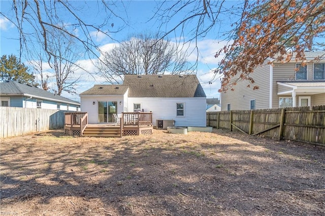 rear view of house with a wooden deck and central air condition unit