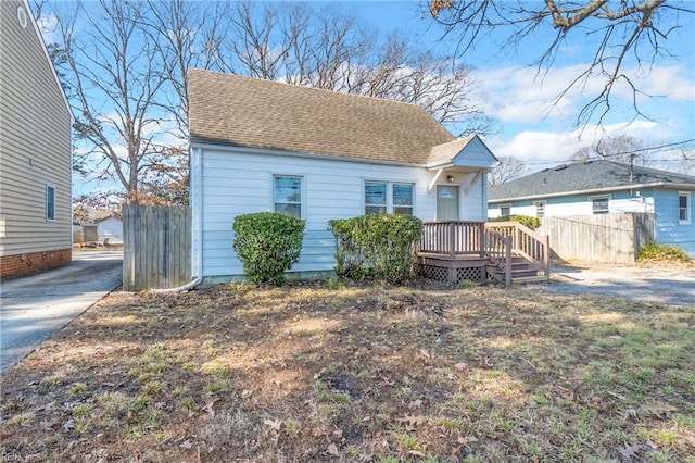 back of property featuring a wooden deck