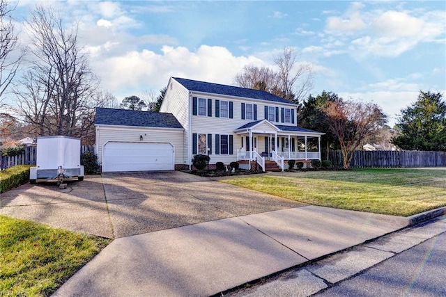 view of front facade featuring a porch, a garage, and a front yard