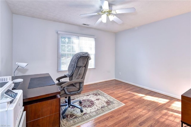 office area with hardwood / wood-style flooring and ceiling fan