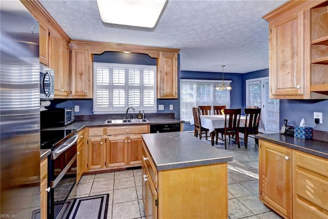 kitchen featuring pendant lighting, sink, appliances with stainless steel finishes, plenty of natural light, and a center island