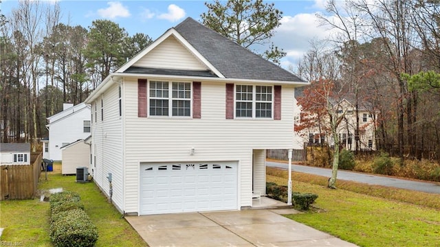 view of front facade featuring a garage, a front yard, and central air condition unit