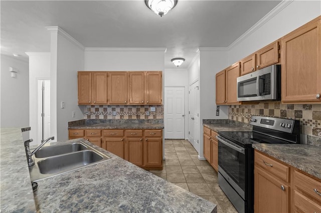 kitchen with sink, light tile patterned floors, ornamental molding, and stainless steel appliances