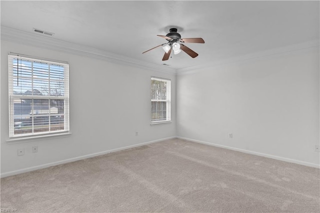 carpeted empty room featuring crown molding and ceiling fan