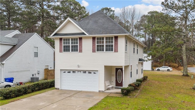 view of front of home featuring cooling unit, a garage, and a front lawn