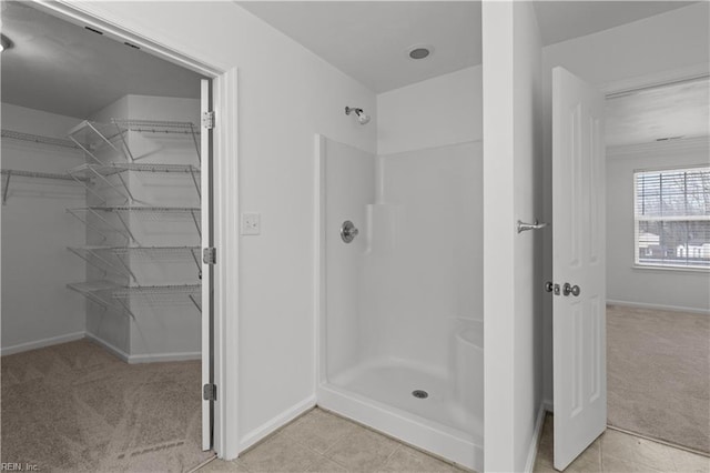 bathroom featuring tile patterned flooring and a shower