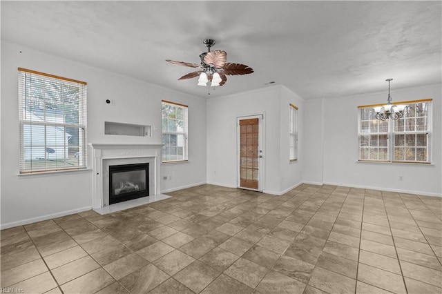 unfurnished living room featuring ceiling fan with notable chandelier and ornamental molding