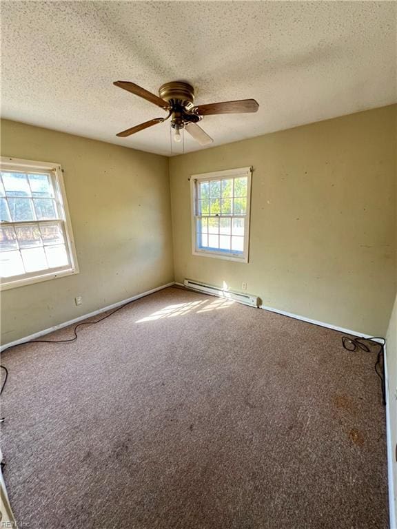 unfurnished room featuring carpet floors, ceiling fan, a baseboard radiator, and a textured ceiling