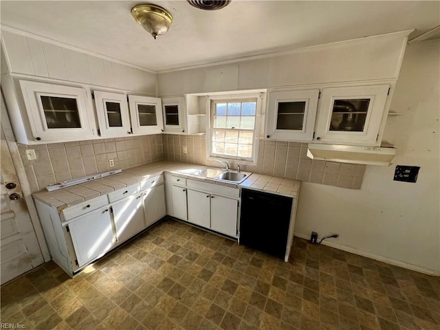 kitchen featuring sink, white cabinets, backsplash, ornamental molding, and tile counters