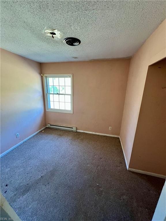 carpeted spare room with a baseboard radiator and a textured ceiling