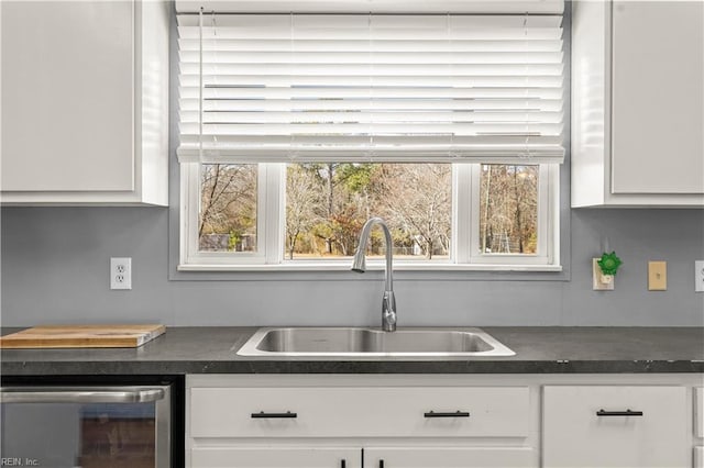 kitchen featuring white cabinetry, sink, wine cooler, and a healthy amount of sunlight