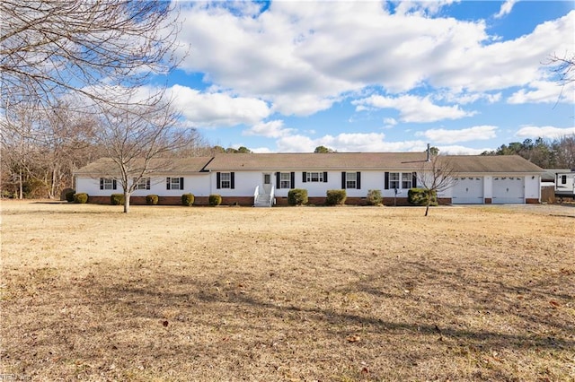 single story home featuring a garage and a front yard