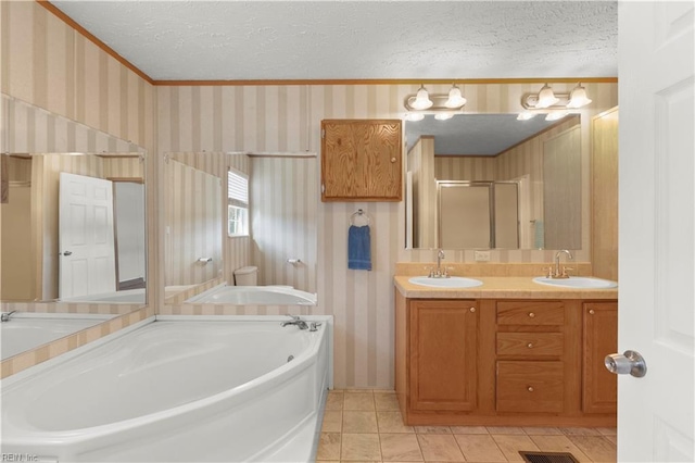 bathroom featuring vanity, plus walk in shower, tile patterned flooring, and a textured ceiling