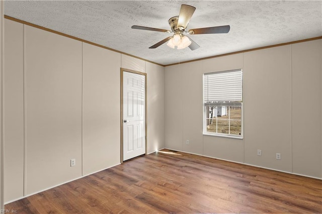 unfurnished room featuring hardwood / wood-style floors, crown molding, a textured ceiling, and ceiling fan