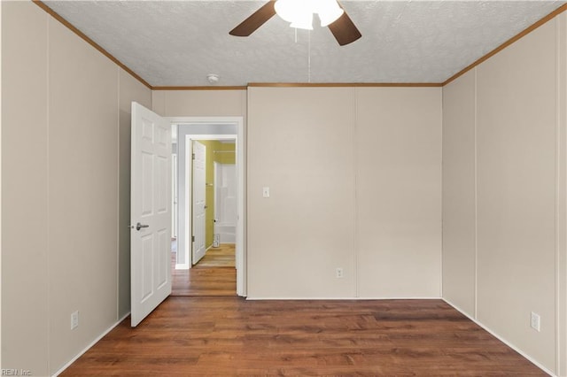 spare room featuring ceiling fan, ornamental molding, wood-type flooring, and a textured ceiling