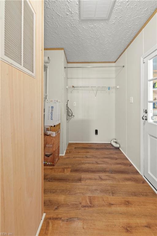 washroom with wood-type flooring and a textured ceiling