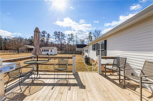 deck featuring an outdoor structure and central AC unit