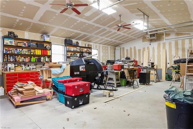 garage featuring ceiling fan and a workshop area