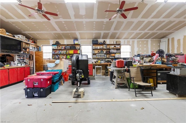 garage featuring ceiling fan and a workshop area