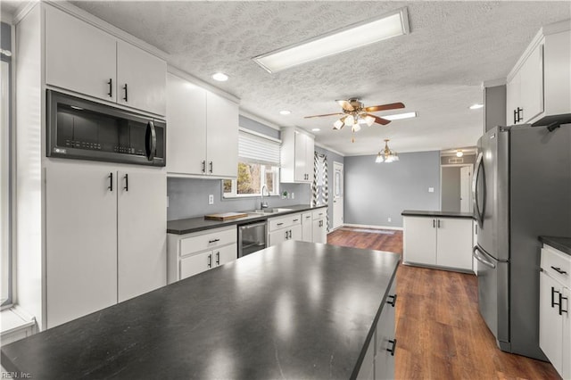 kitchen featuring dark wood-type flooring, stainless steel refrigerator, wine cooler, a textured ceiling, and white cabinets