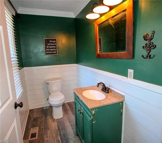 bathroom featuring crown molding, hardwood / wood-style floors, vanity, and toilet