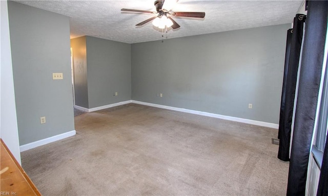 carpeted spare room with ceiling fan and a textured ceiling