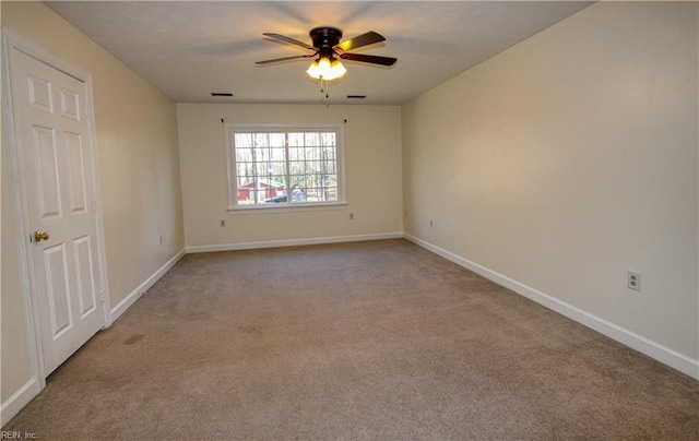 unfurnished room with ceiling fan and carpet flooring