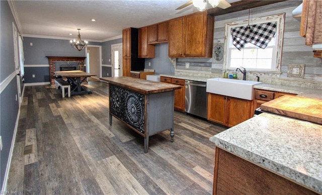 kitchen with butcher block counters, sink, a center island, and dishwasher