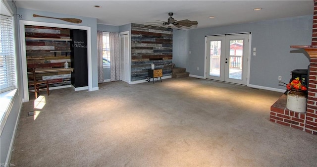 unfurnished living room featuring carpet floors, french doors, and ceiling fan