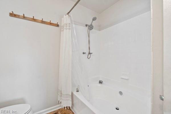 bathroom with shower / tub combo and toilet