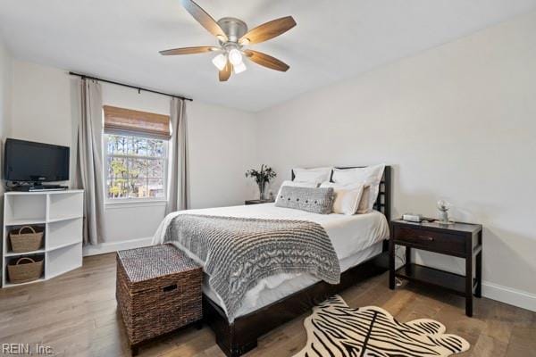 bedroom featuring hardwood / wood-style floors and ceiling fan