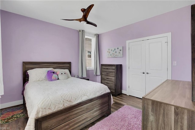 bedroom featuring wood-type flooring, ceiling fan, and a closet