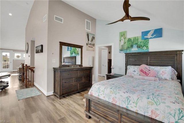 bedroom with light hardwood / wood-style flooring, high vaulted ceiling, and ceiling fan