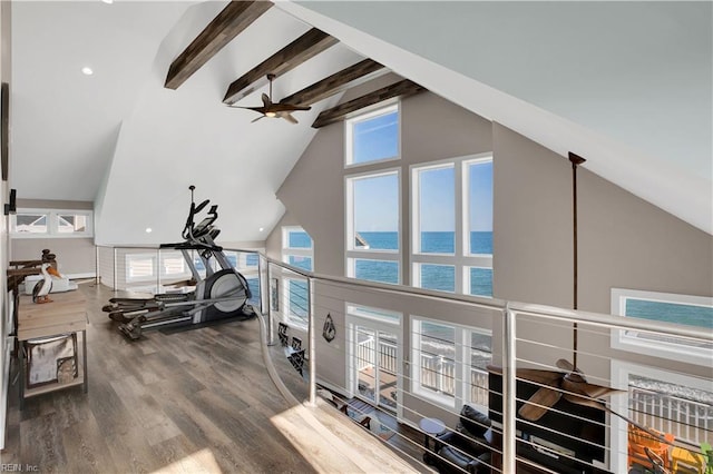 workout room featuring hardwood / wood-style flooring, a water view, high vaulted ceiling, and ceiling fan