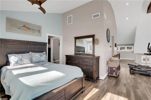 bedroom featuring high vaulted ceiling and light wood-type flooring