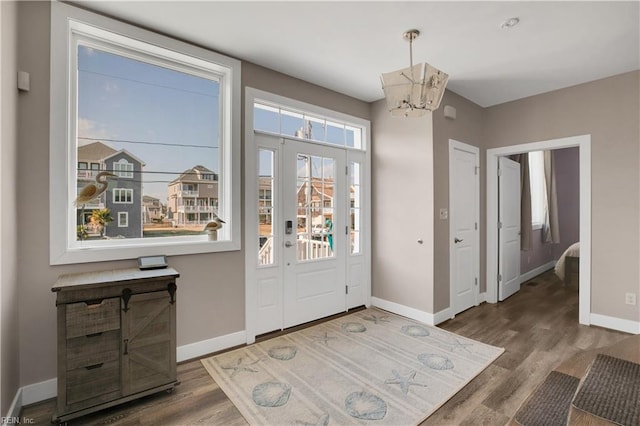 entryway featuring a notable chandelier and wood-type flooring