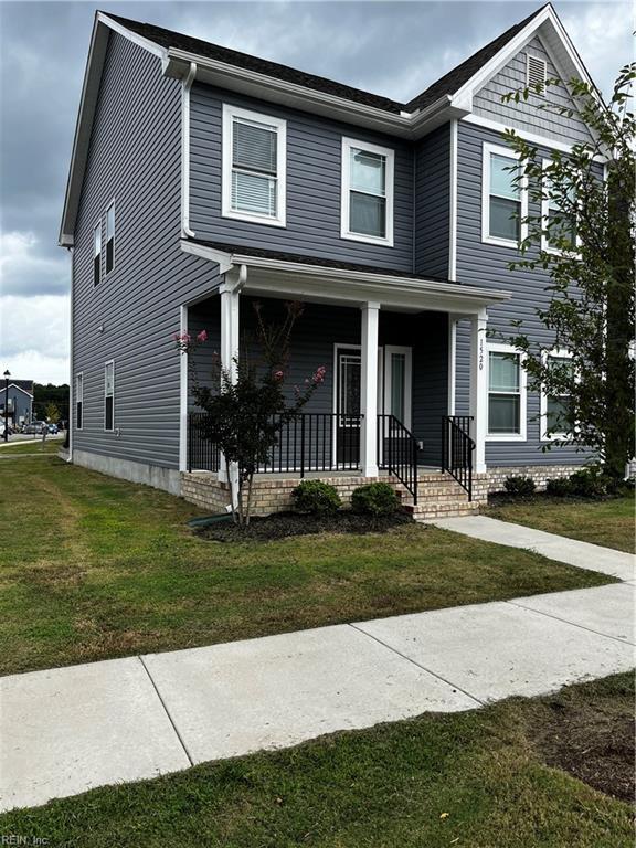 view of front of property featuring a front lawn and covered porch