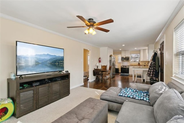 living room with crown molding, ceiling fan, and dark hardwood / wood-style flooring