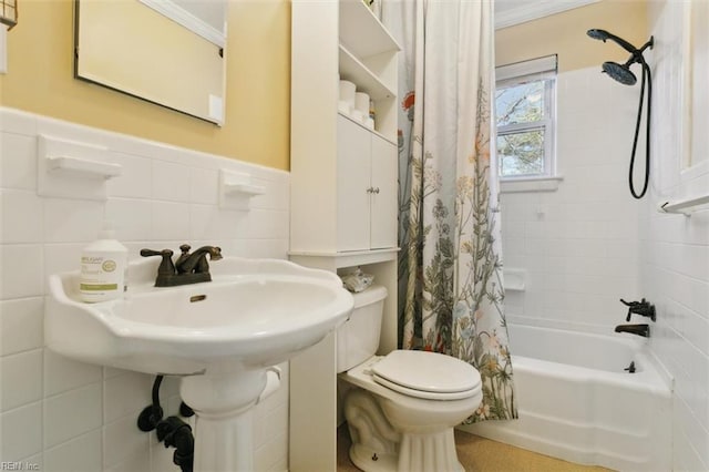 bathroom featuring toilet, shower / bath combo with shower curtain, and tile walls