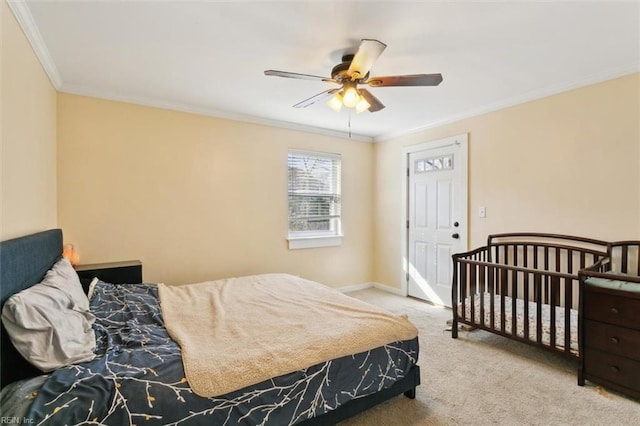 bedroom with crown molding, light colored carpet, and ceiling fan