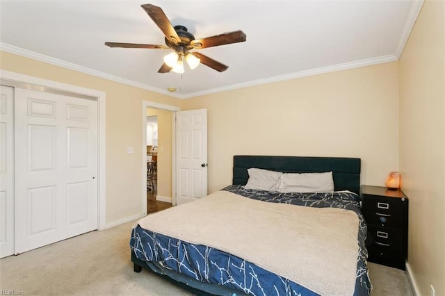 carpeted bedroom with ceiling fan and ornamental molding