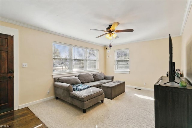 living room featuring ceiling fan and ornamental molding