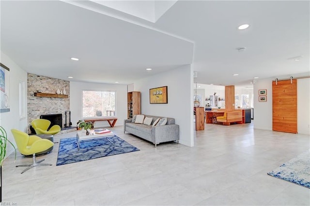 living room featuring a fireplace and a barn door