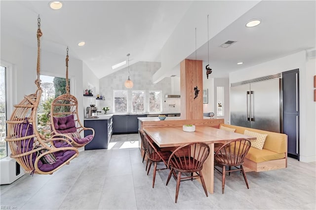 tiled dining room with vaulted ceiling