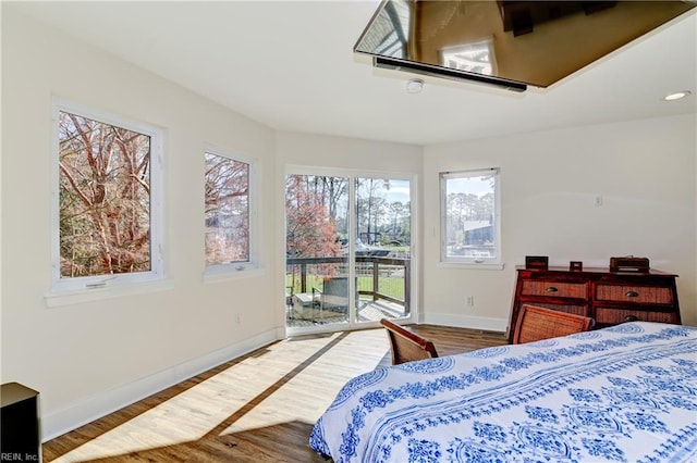 bedroom with hardwood / wood-style flooring and access to exterior