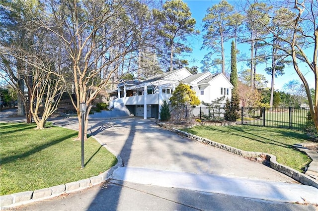 split foyer home featuring a garage and a front lawn