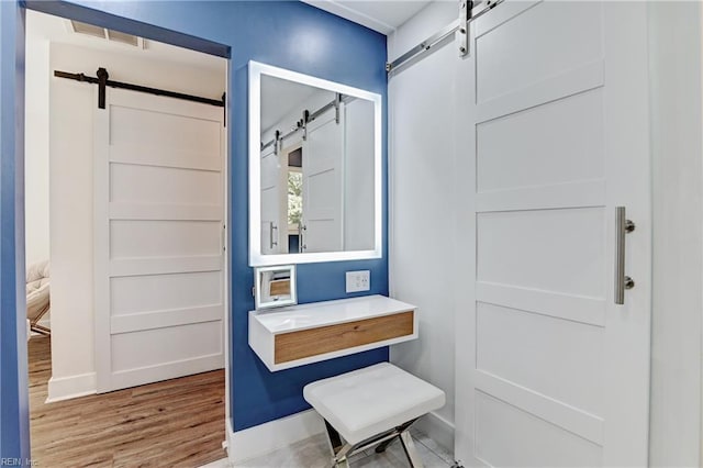 interior space with a barn door and light hardwood / wood-style flooring