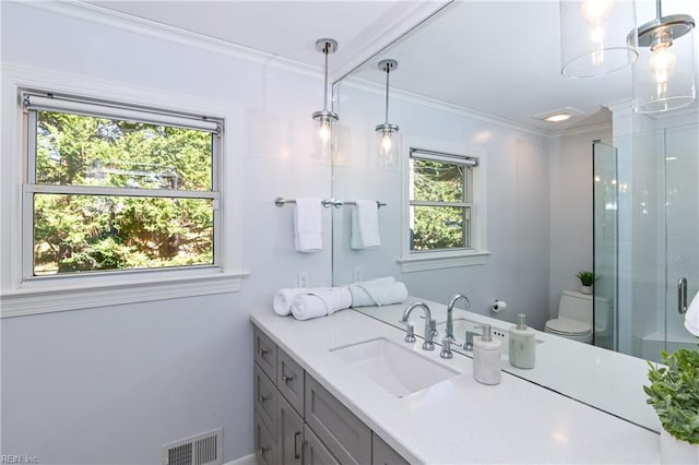 bathroom with vanity, crown molding, a shower with shower door, and toilet