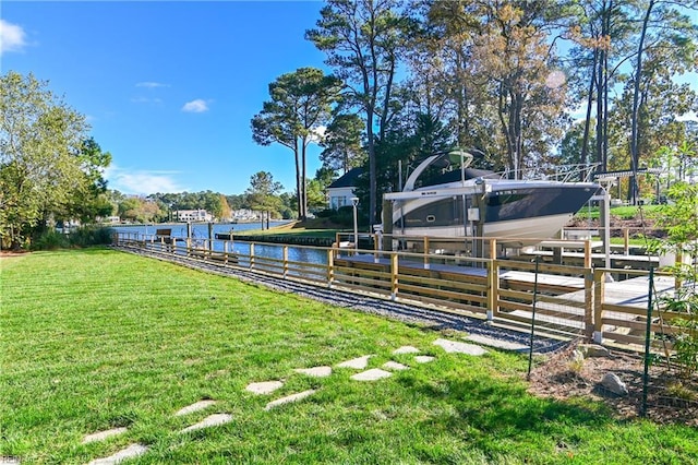 view of yard with a dock and a water view